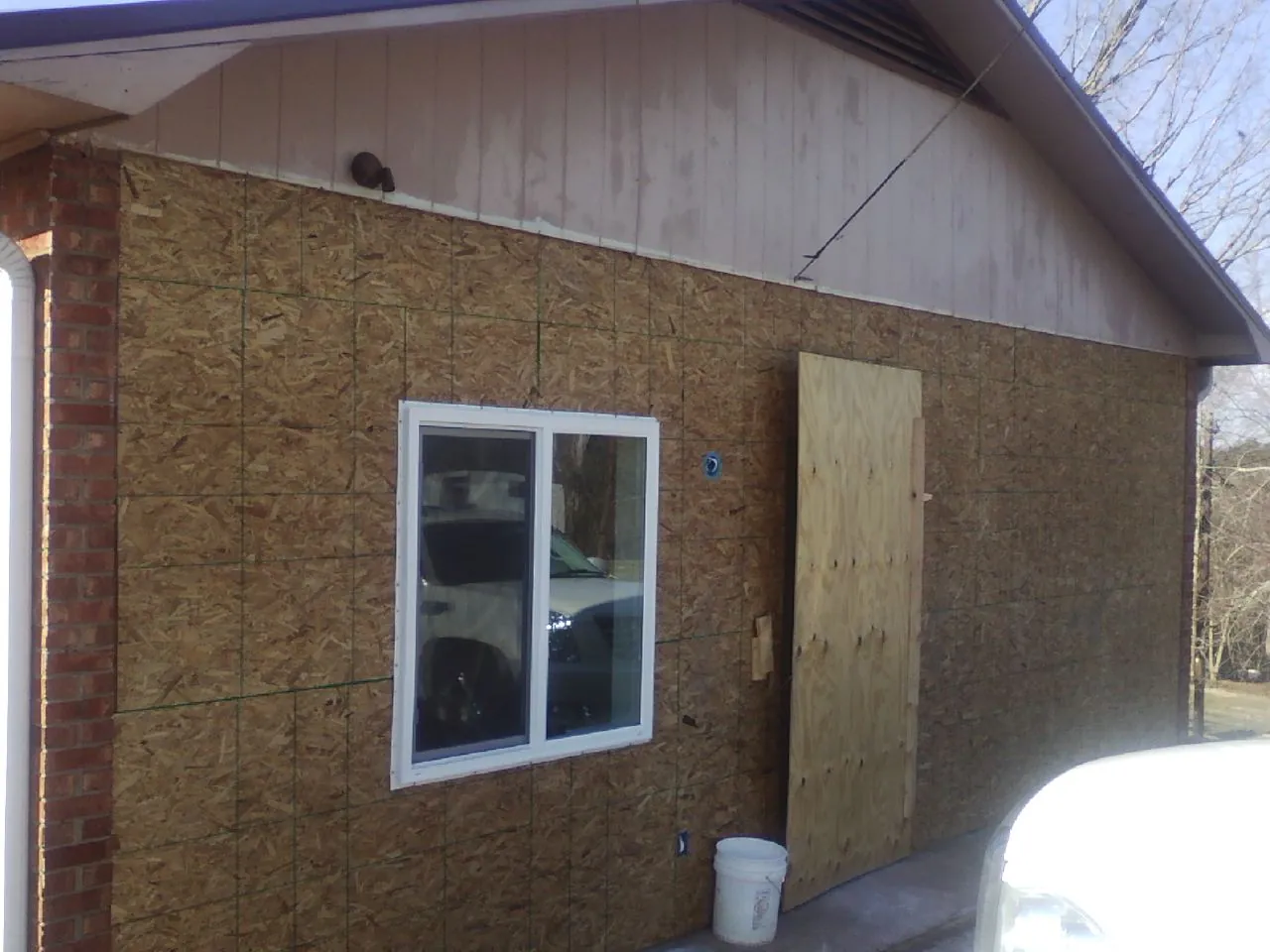 OSB sheathing on a garage addition wall before siding in Moravia